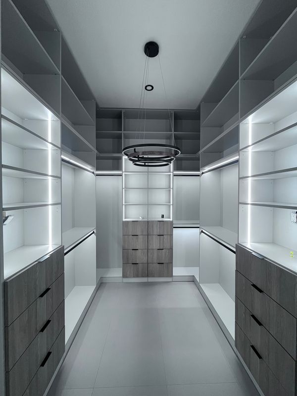 Walk-in closet with LED lighting and chandelier
