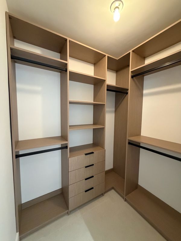 Natural oak closet with black rods