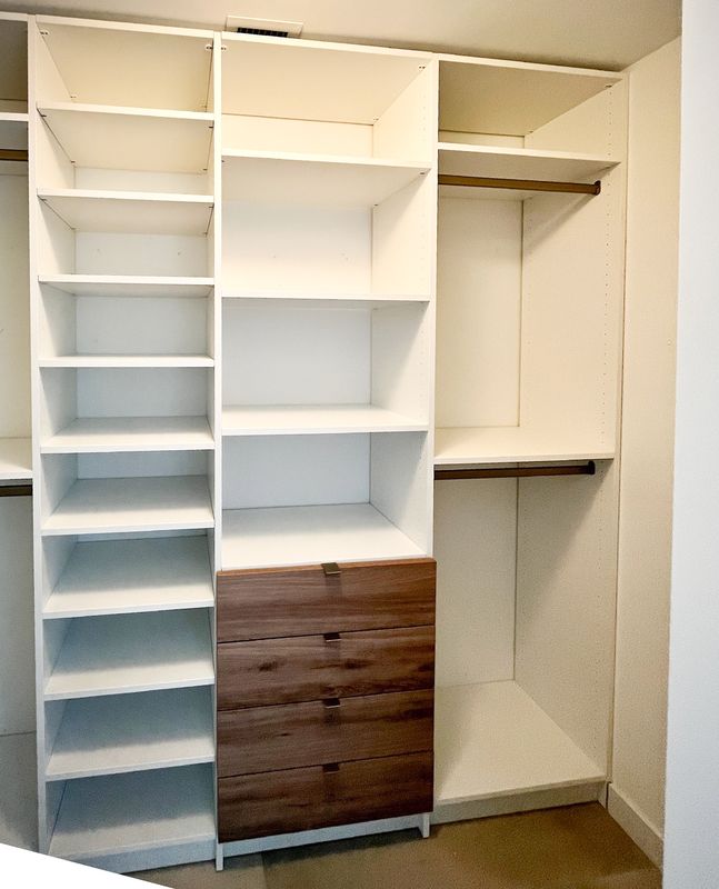 Closet with walnut drawers and shelving
