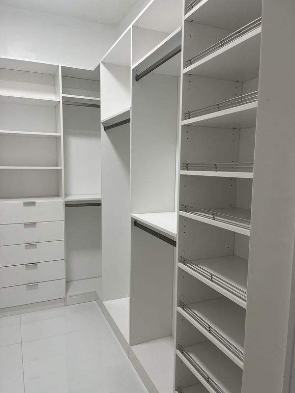 White closet with shoe shelves and drawers