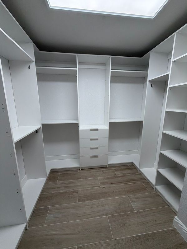White walk-in closet with drawer tower