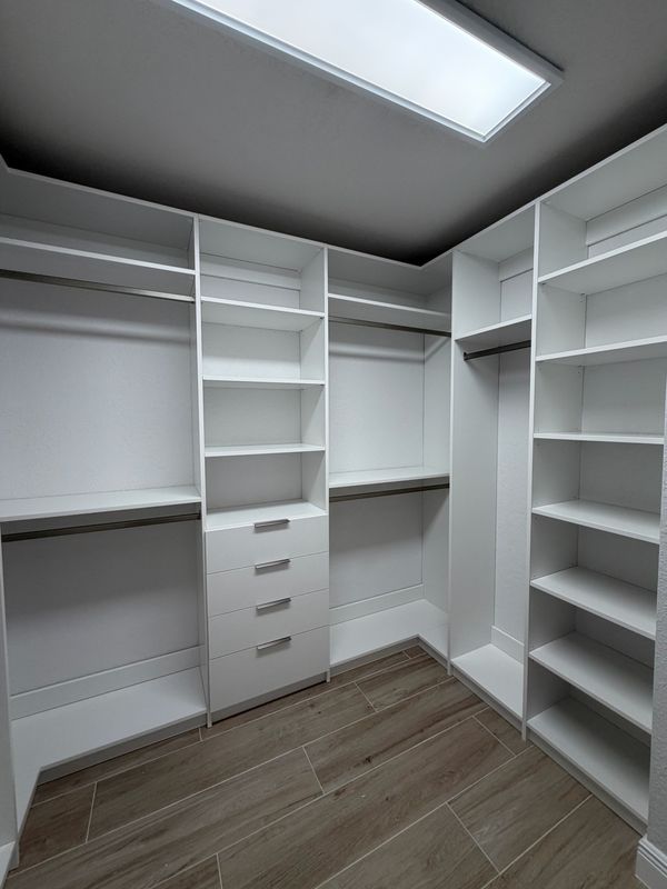 White walk-in closet with skylight
